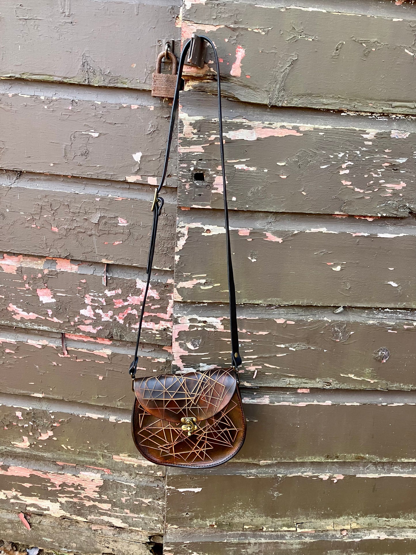 the sarah crossbody in black and brown cut