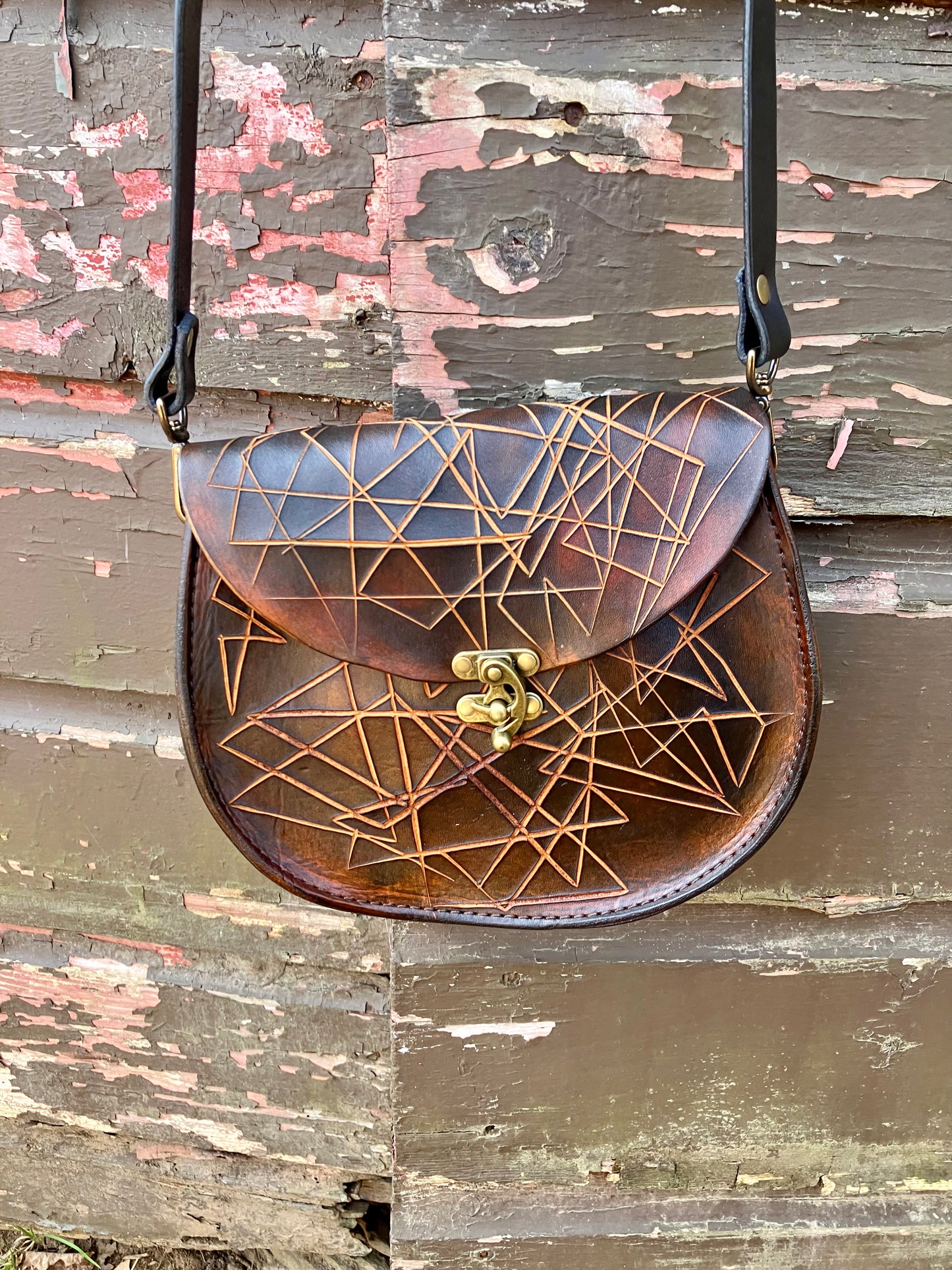 the sarah crossbody in black and brown cut
