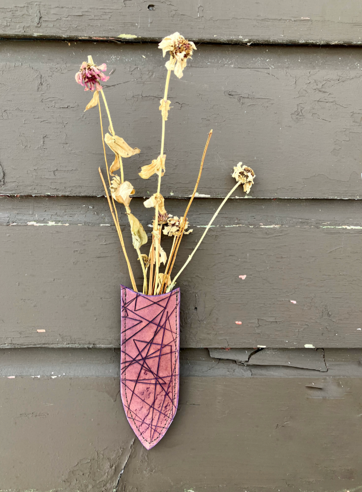 a wilder leather handcrafted leather air vase is perfect for dried flowers or other things you wish to suspend on the wall.