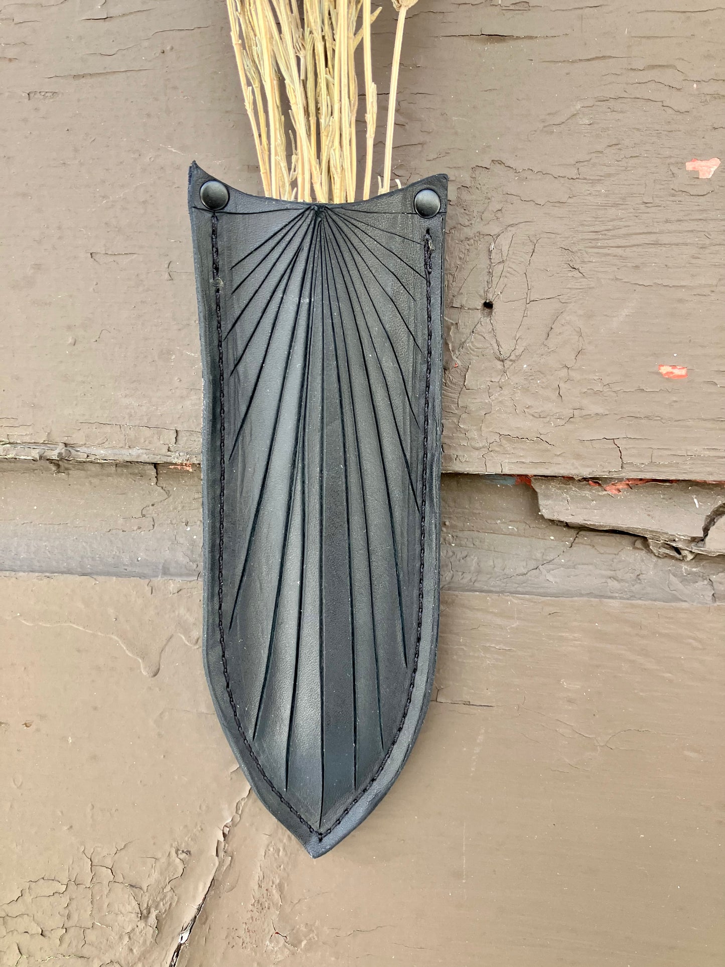 a wilder leather handcrafted leather air vase is perfect for dried flowers or other things you wish to suspend on the wall.