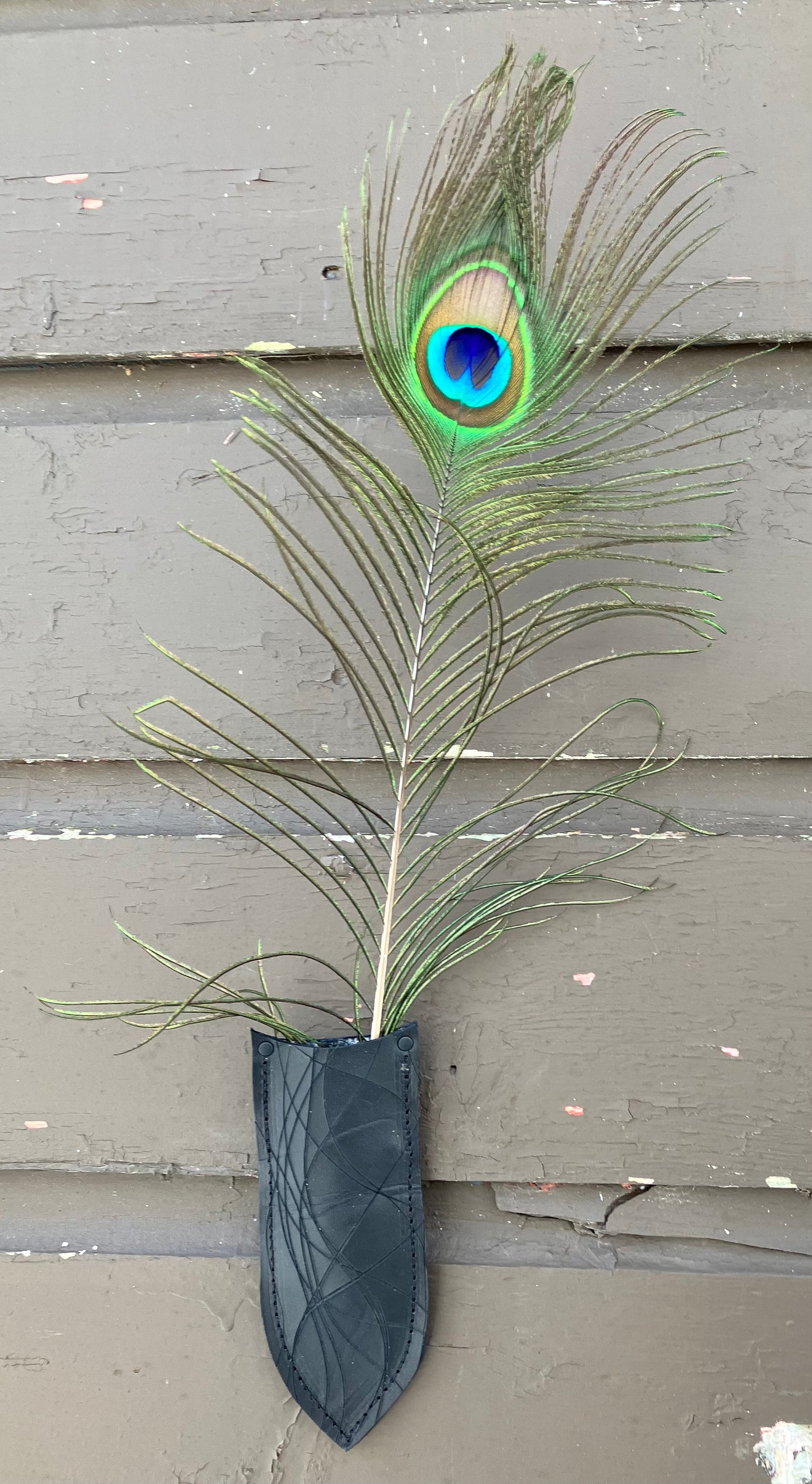 a wilder leather handcrafted leather air vase is perfect for dried flowers or other things you wish to suspend on the wall.