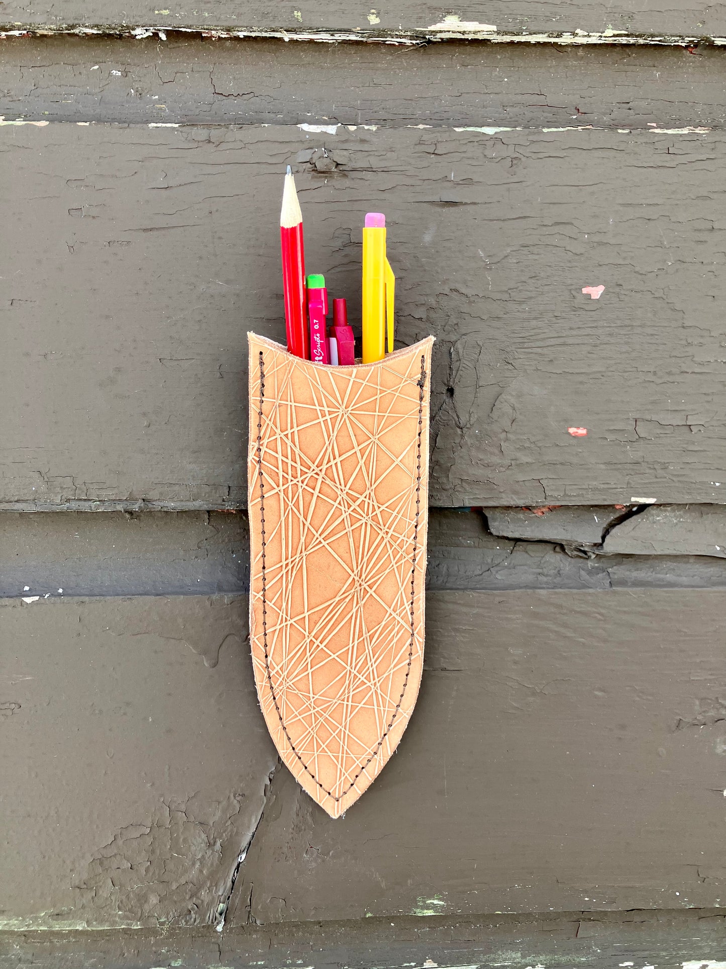 a wilder leather handcrafted leather air vase is perfect for dried flowers or other things you wish to suspend on the wall.