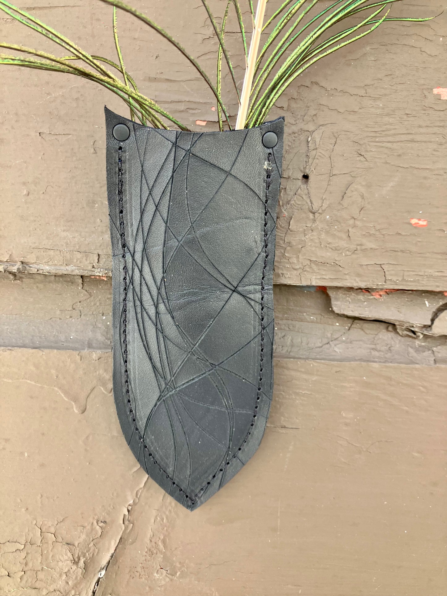 a wilder leather handcrafted leather air vase is perfect for dried flowers or other things you wish to suspend on the wall.