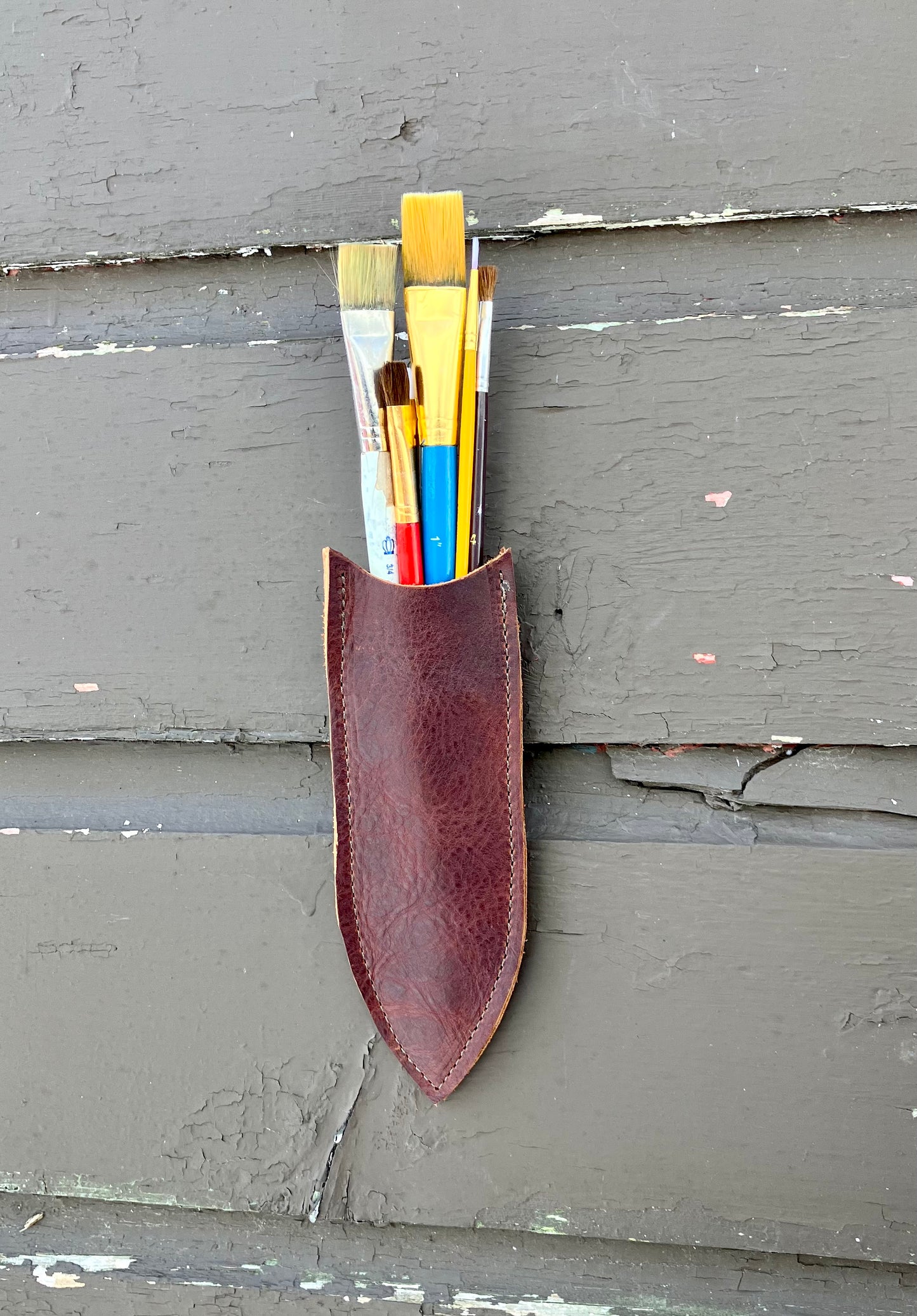 a wilder leather handcrafted leather air vase is perfect for dried flowers or other things you wish to suspend on the wall.