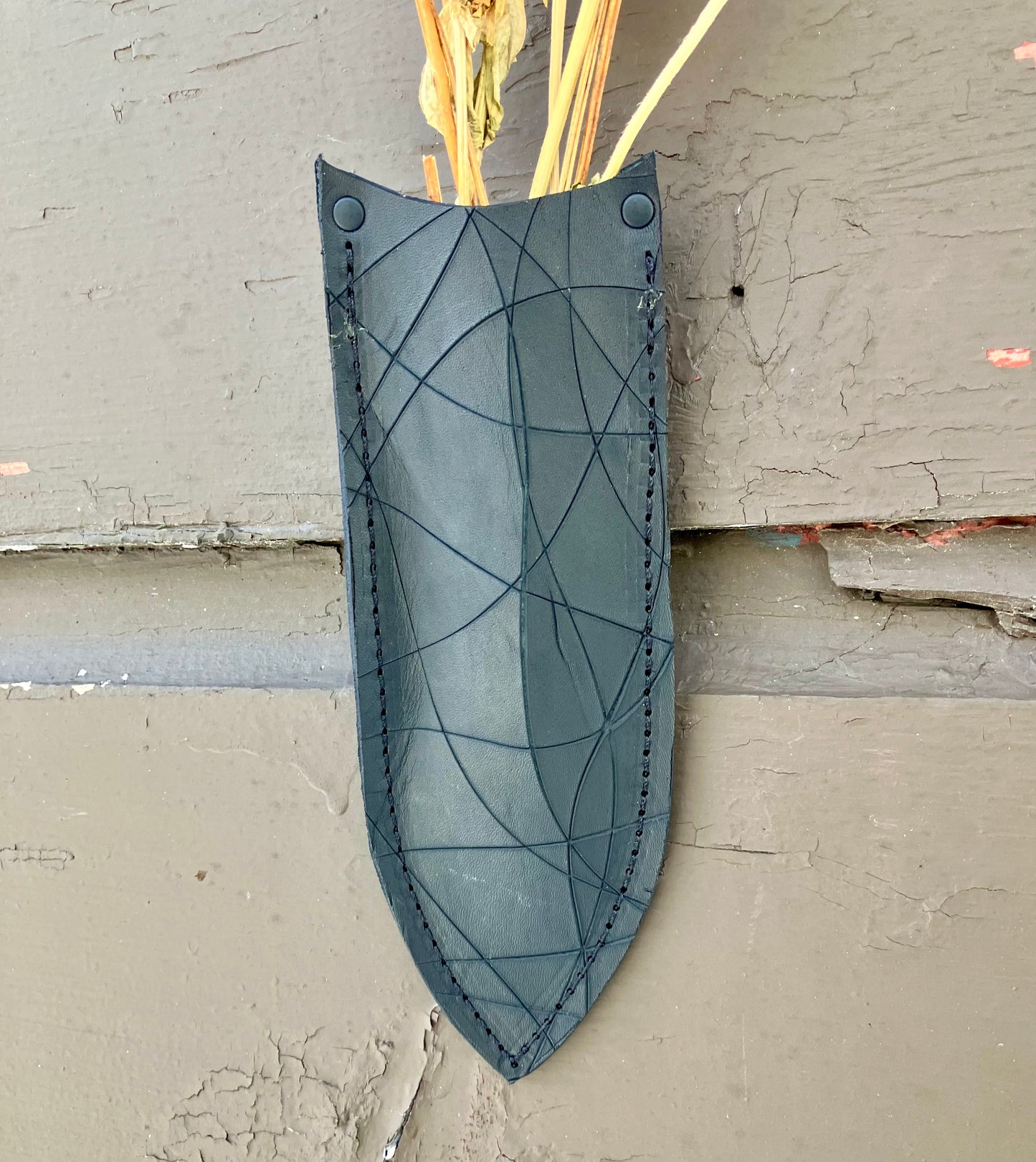 a wilder leather handcrafted leather air vase is perfect for dried flowers or other things you wish to suspend on the wall.