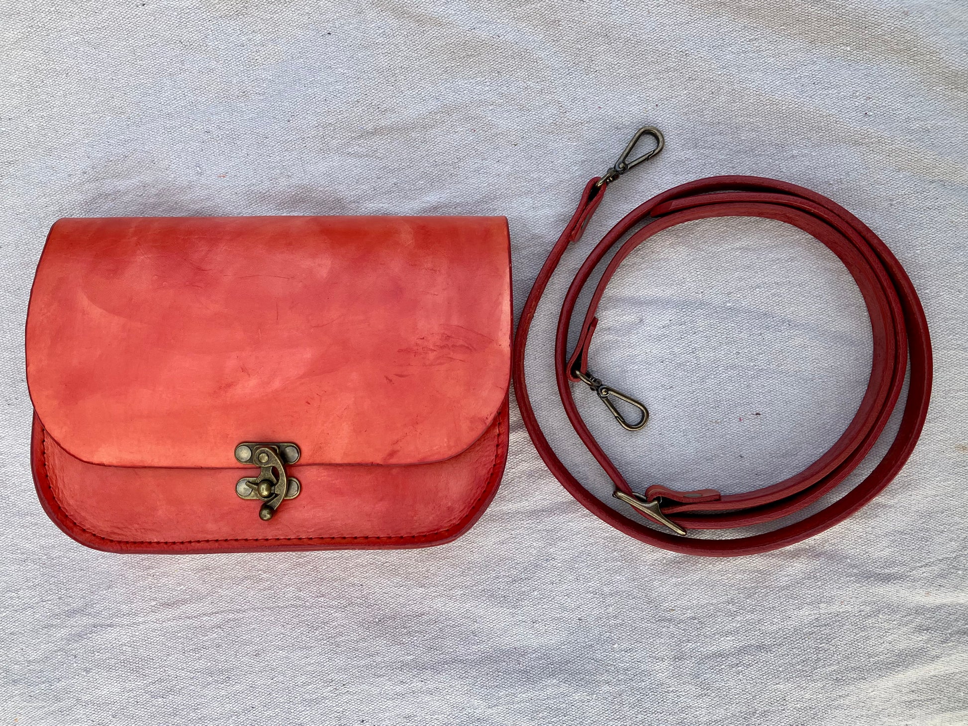 orange handmade leather bag/belt-bag hybrid with crossbody strap by Wilder Leather.
