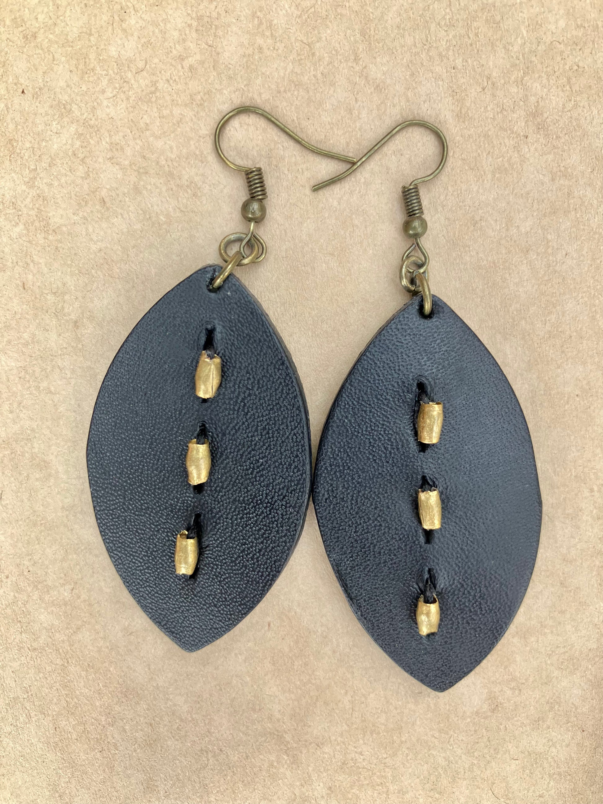 lightweight leather earrings with embossed lines; hypoallergenic, nickel free; antique brass; 3 inch high; handmade.