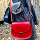 The Cheryl in red leather is the first of its kind. other bags (not red) shown for comparison. handmade by Wilder Leather in Woodstock, NY