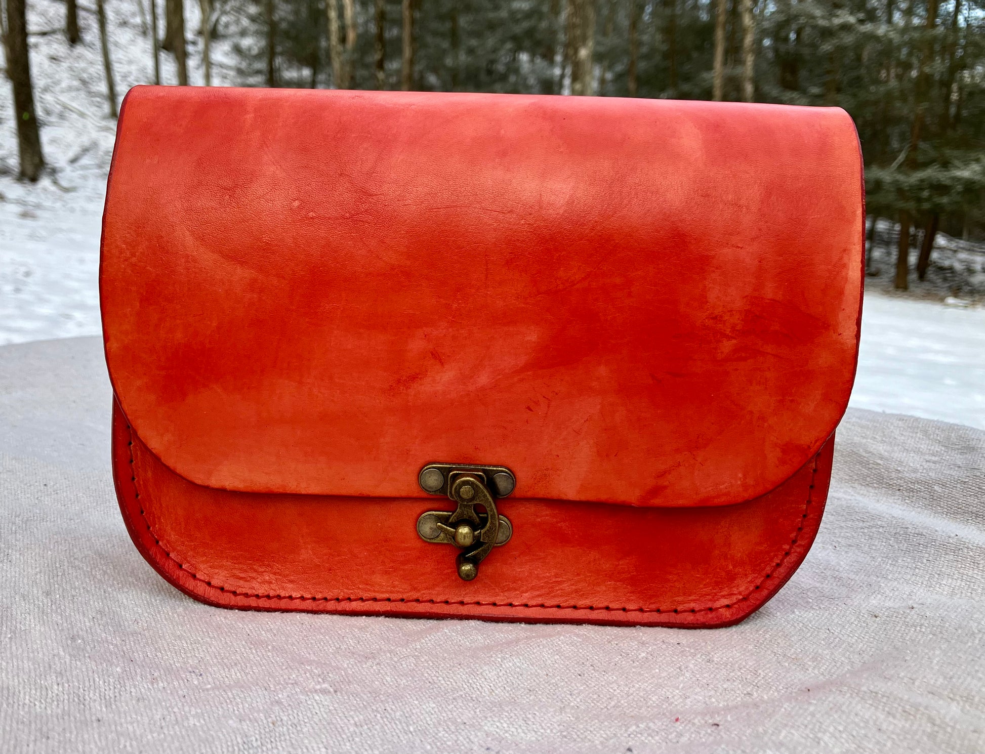 orange handmade leather bag/belt-bag hybrid with crossbody strap by Wilder Leather.