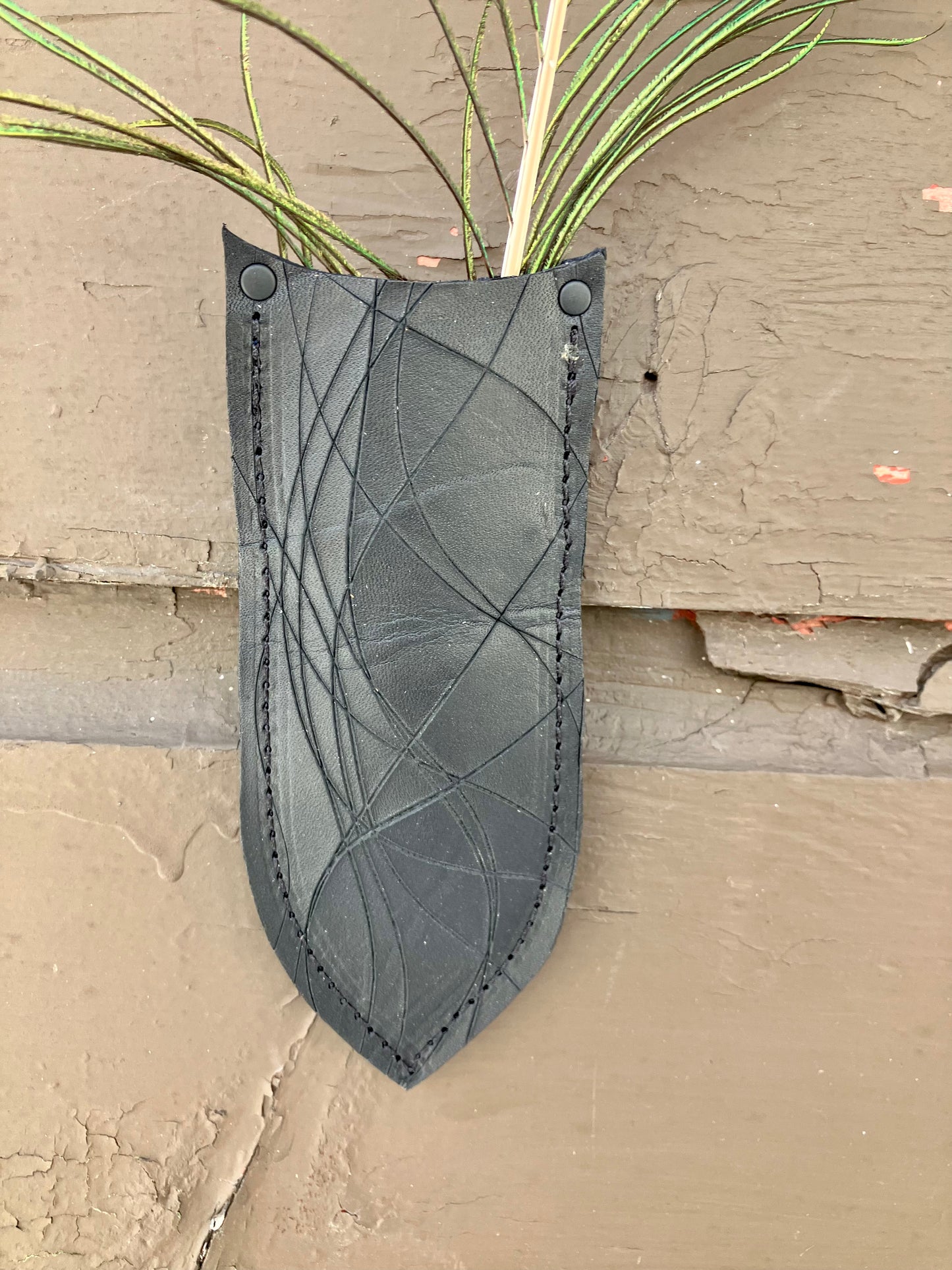 a wilder leather handcrafted leather air vase is perfect for dried flowers or other things you wish to suspend on the wall. 